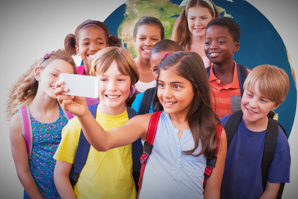 Cute pupils using mobile phone against white background with vignette