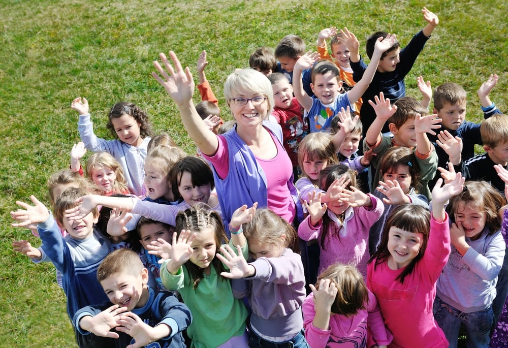 happy child kids group have fun and play at kindergarden preschool education concept with teacher